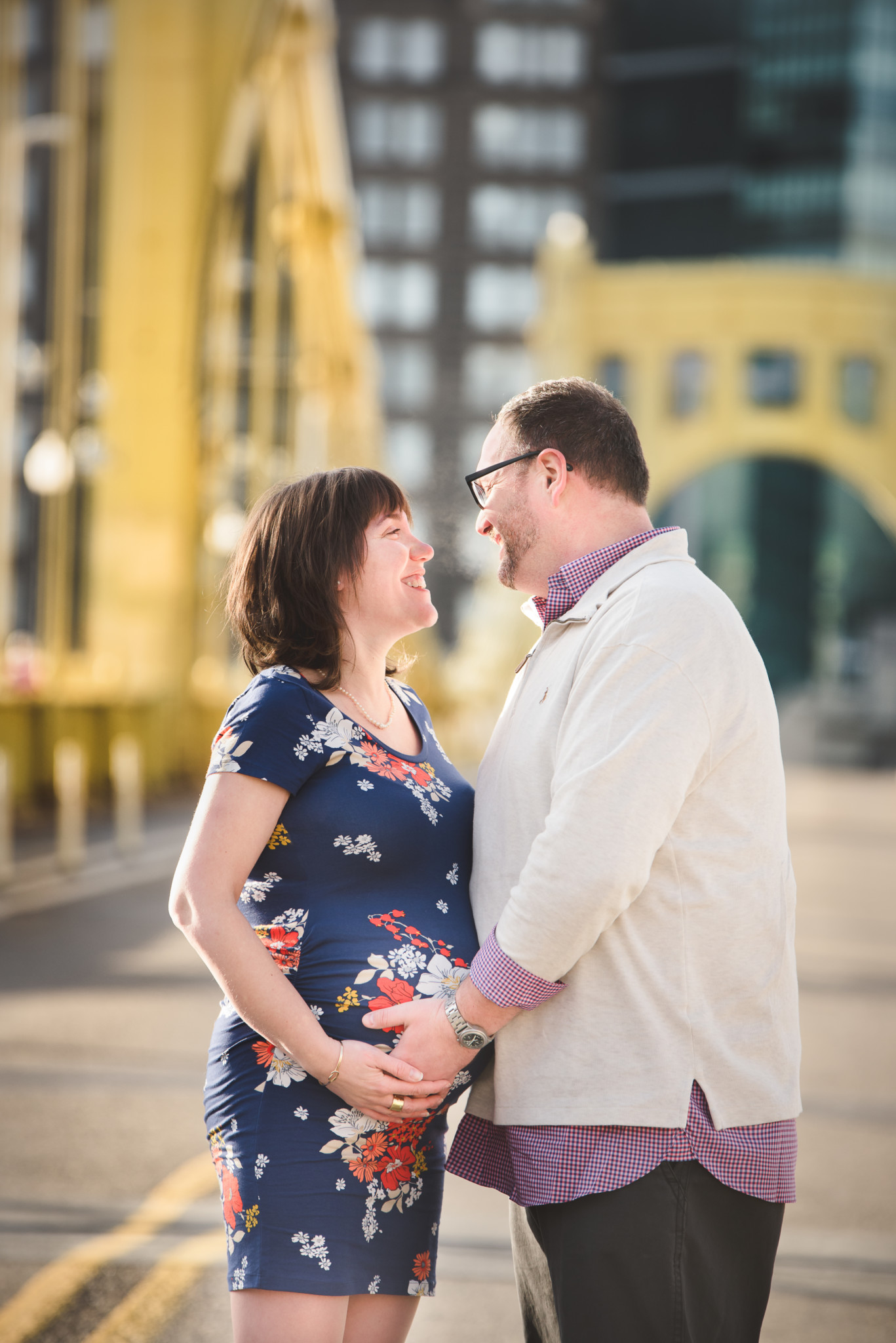 Pregnant couple are in Downtown Pittsburgh for Maternity Photos on the Clemente Bridge